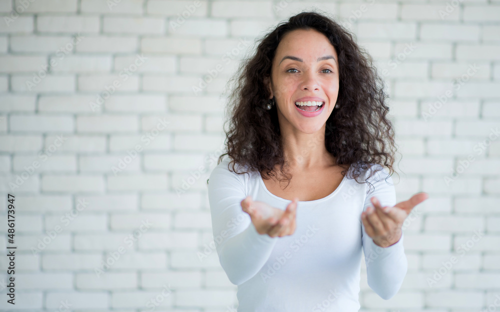 Amazed excited young woman afro hairstyle raising hands in surprise looking at camera with big eyes, shocked by sudden victory.studio shot isolated on white background Amazed excited young woman afro hairstyle raising hands in surprise looking at camera with big eyes, shocked by sudden victory.studio shot isolated on white background