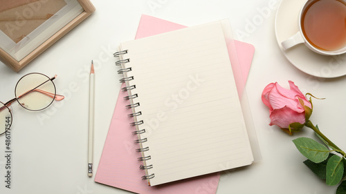 Beautiful feminine female office desk with empty notebook cover mockup photo