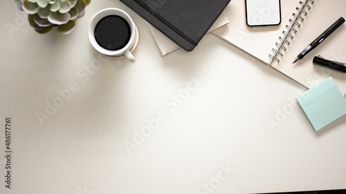 Modern office desk table with supplies and copy space on white background.
