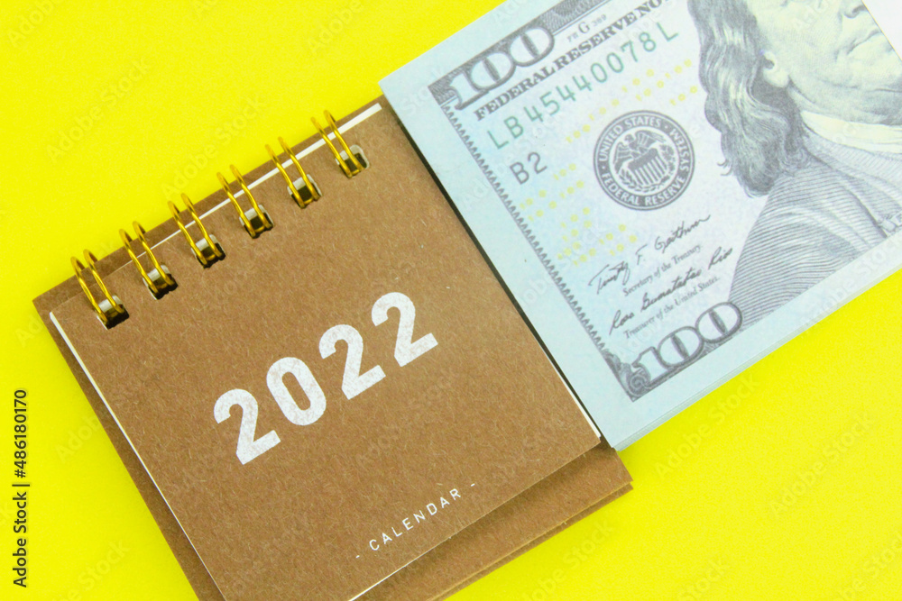 the concept of the 2022 calendar and money the concept of the 2022 calendar and money