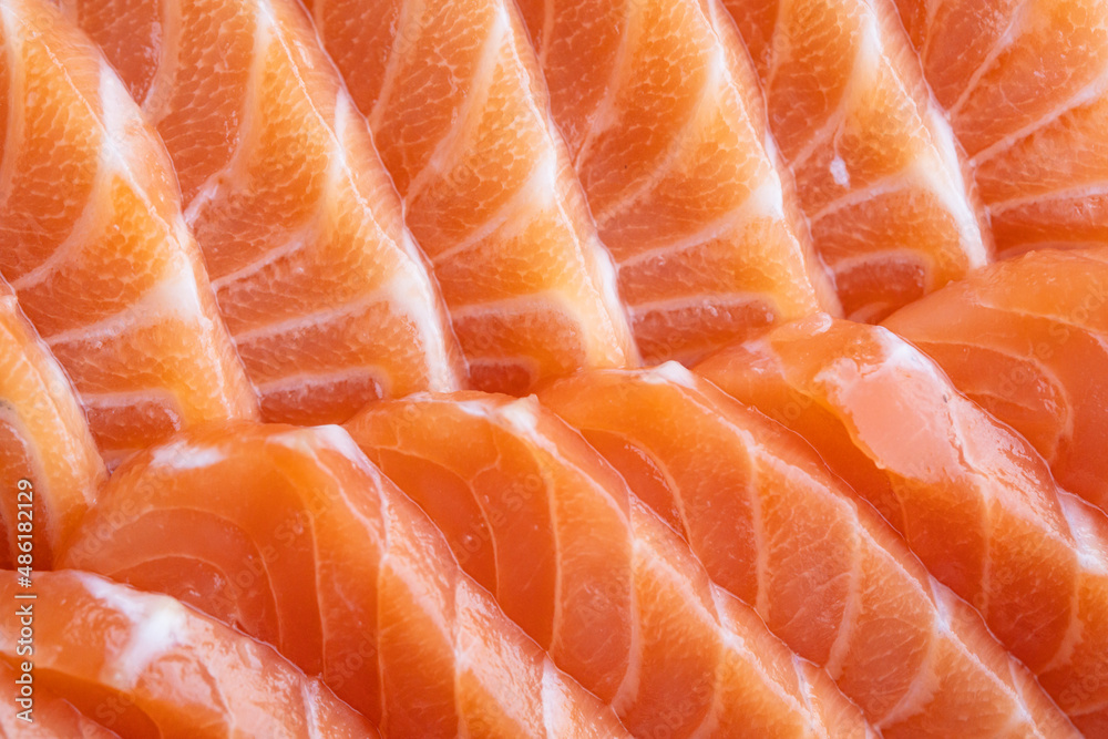 close up salmon fillet slices texture.Row salmon fish sliced on plate at Japanese restaurant.