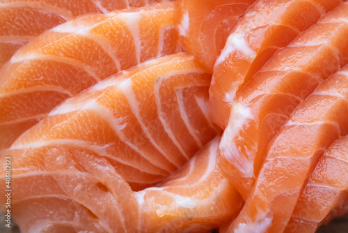close up salmon fillet slices texture.Row salmon fish sliced on plate at Japanese restaurant.