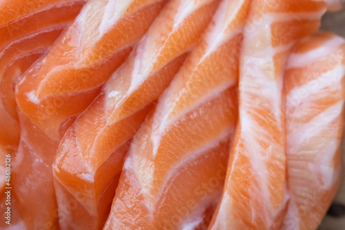 close up salmon fillet slices texture.Row salmon fish sliced on plate at Japanese restaurant.