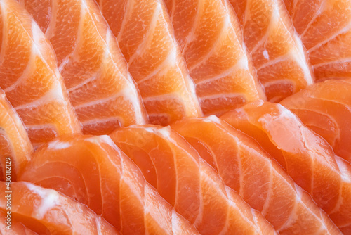 close up salmon fillet slices texture.Row salmon fish sliced on plate at Japanese restaurant.
