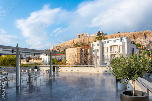 View from an empty outdoor terrace patio of the Parthenon and Acropolis Hill in Athens, Greece.
