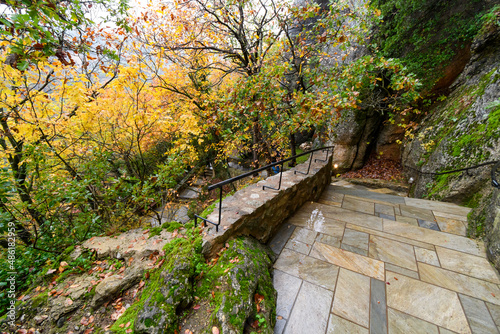 The steep path of steps that cllimb the hill to the Roussanou Monastery Saint Barbara on a rainy day in the historic World Heritage Site of Meteora, Greece. photo