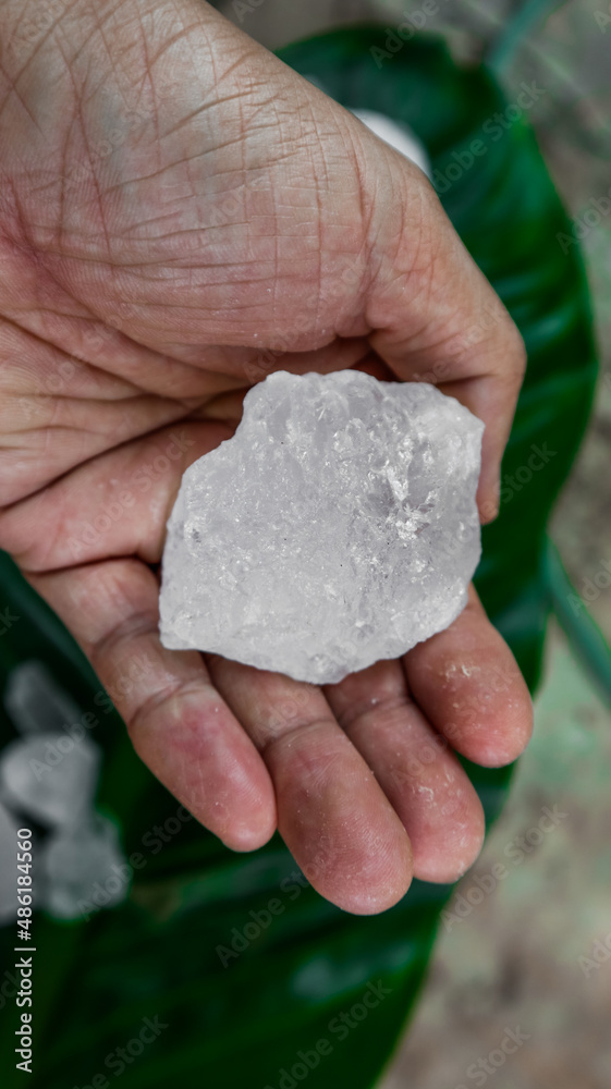 Crystal clear alum cubes or Potassium alum on palm. Chemical compound substance. Concept for beauty , spa and underarm treatment industrial. Crystal clear alum cubes or Potassium alum on palm. Chemical compound substance. Concept for beauty , spa and underarm treatment industrial.