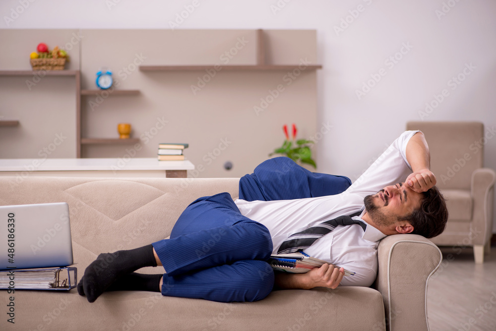 Young male employee working from home during pandemic Young male employee working from home during pandemic