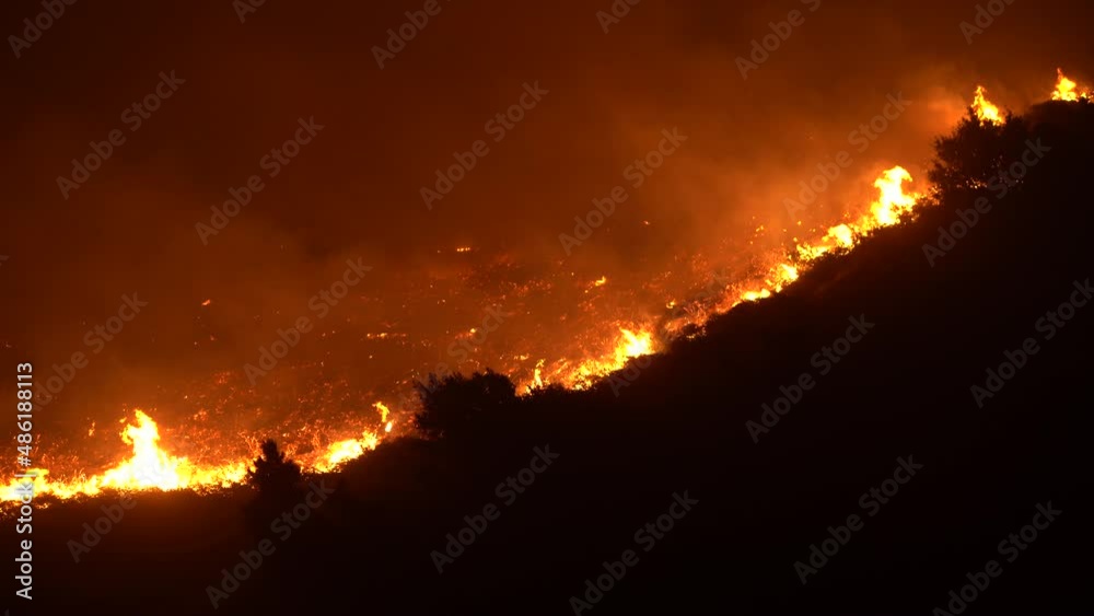 flames race down large hillside flames race down large hillside