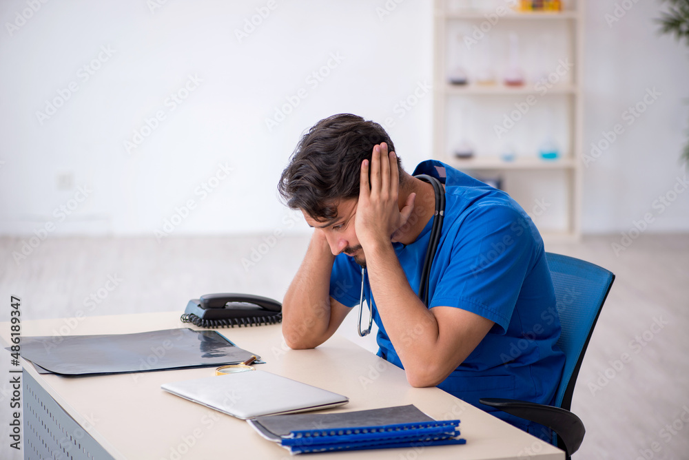 © Elnur - Young male doctor working in the clinic