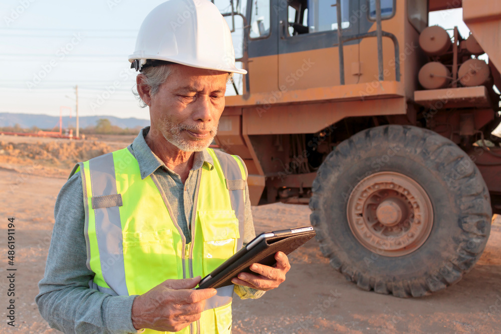 A senior mining engineer enjoys his work in the evening sun. A senior mining engineer enjoys his work in the evening sun.