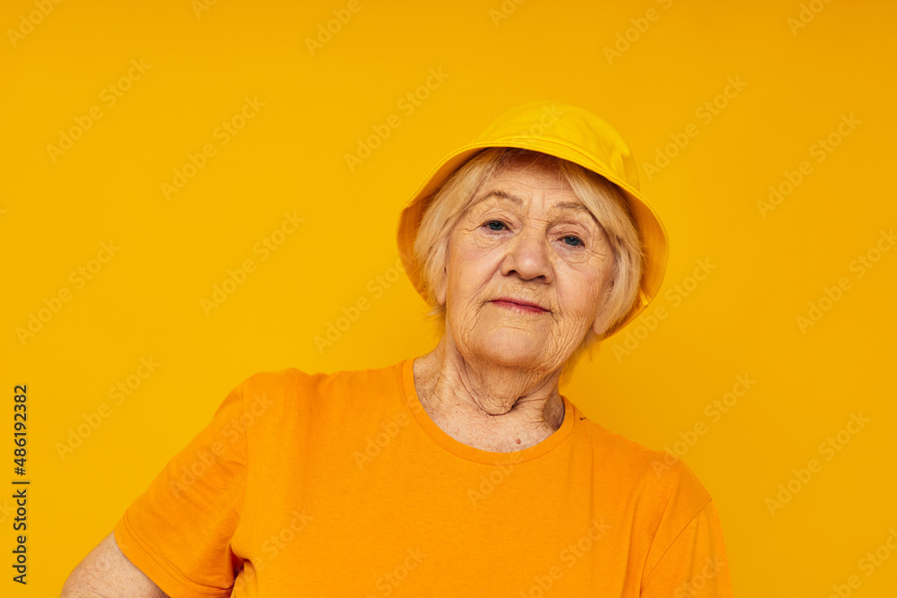 elderly woman happy lifestyle in a yellow headdress close-up emotions
