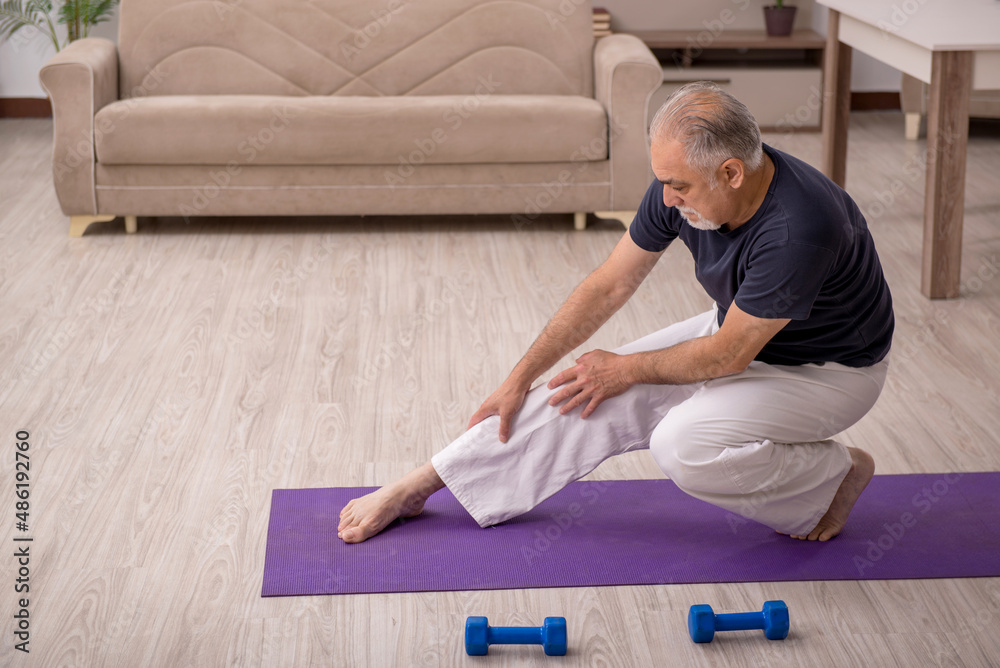 Old man doing sport exercises at home Old man doing sport exercises at home