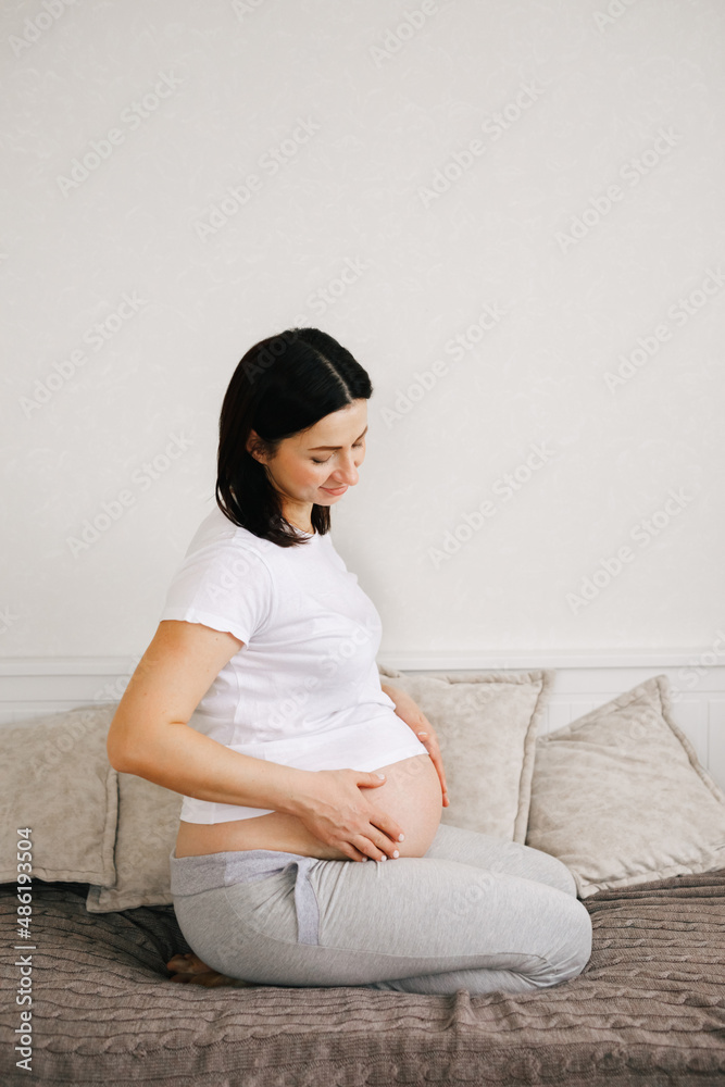 Pregnant expectant mother gently hugging her belly . Woman hands touching her tummy, waiting child. Preparation for childbirth Pregnant expectant mother gently hugging her belly . Woman hands touching her tummy, waiting child. Preparation for childbirth