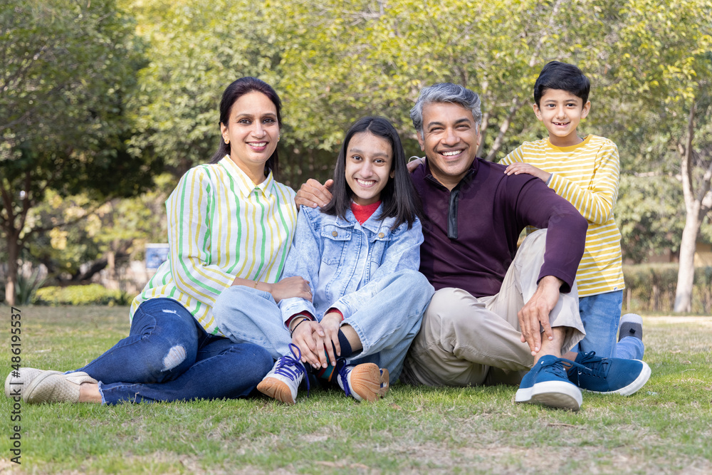 Portrait of happy Indian family spending leisure time at park Portrait of happy Indian family spending leisure time at park