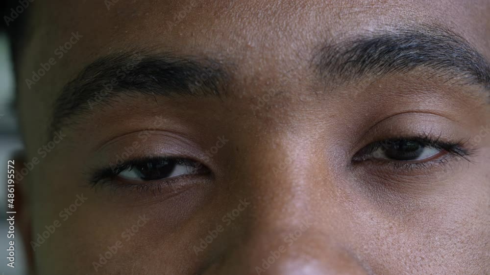A black man eyes close-up looking at camera an african person macro