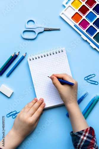 children's hands in front of a blank sheet, top view, space for text, creativity