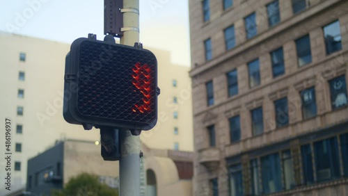 Red stopsignal hand up on crosswalk city close up. Regulation signal on pole photo