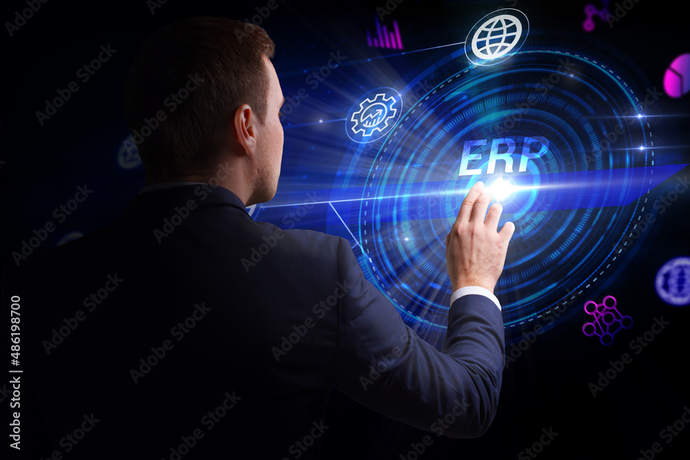 Business, Technology, Internet and network concept. Young businessman working on a virtual screen of the future and sees the inscription: ERP Business, Technology, Internet and network concept. Young businessman working on a virtual screen of the future and sees the inscription: ERP