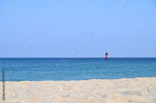 Beautiful beach and a lighthouse that can be seen far away