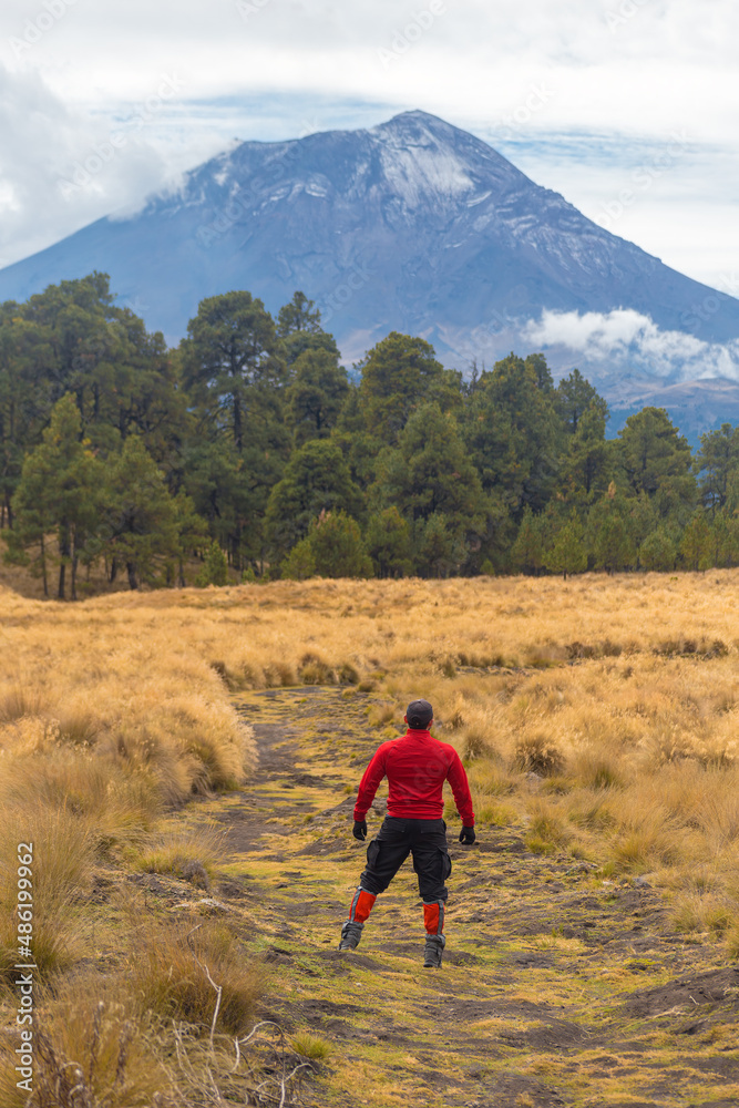 Mountaineer Walking On The Mountain with view at popocatepetl volcano