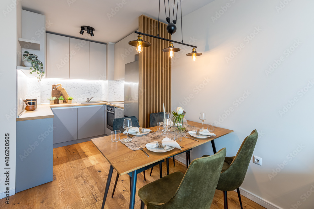 Fototapeta premium New modern kitchen with table served for dinner. New home. Interior photography.