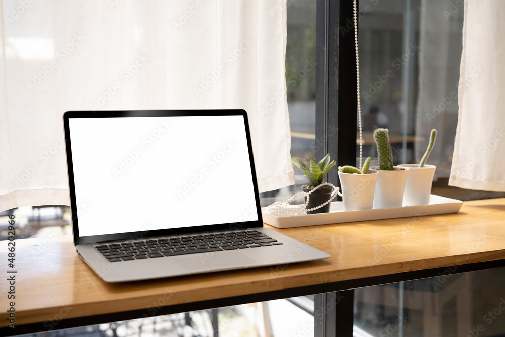 Mockup computer laptop with white blank display on wooden table. Mockup computer laptop with white blank display on wooden table.