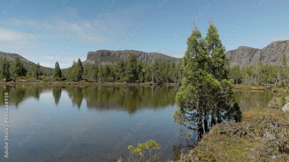 calm summer morning shot of the pool of siloam and pencil pines at walls of jerusalem national park in tasmania, australia calm summer morning shot of the pool of siloam and pencil pines at walls of jerusalem national park in tasmania, australia