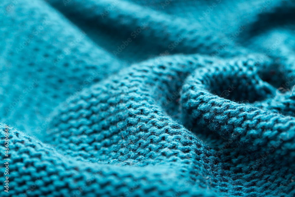Knitted surface of woolen things as a background. Close-up of soft blue knitted patterns texture. Warm winter clothes. Background textile surface with copy space for text. Knitted surface of woolen things as a background. Close-up of soft blue knitted patterns texture. Warm winter clothes. Background textile surface with copy space for text.