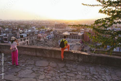 Photography travelers of the European race, a man and a woman look down and photograph the s