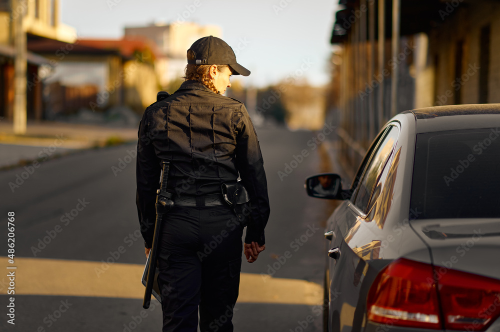 Female cop coming to car on road