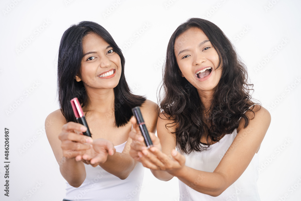 girl friend applying lipstick and showing the product to camera girl friend applying lipstick and showing the product to camera