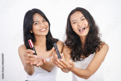 girl friend applying lipstick and showing the product to camera