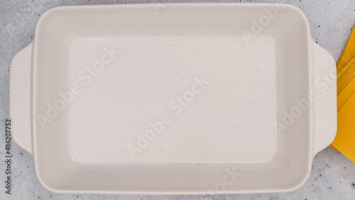 White baking dish close up on light grey background