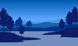 Incredible mountain view at night from the lakeside with the silhouettes of pine trees all around