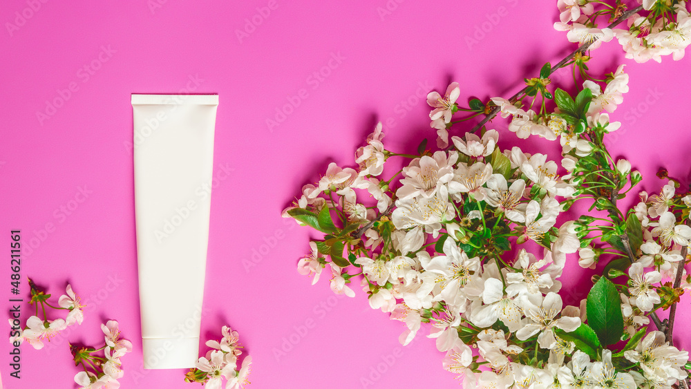 Obraz premium Cosmetic cream tube packaging on pink background. Beauty, skincare and natural cosmetics concept. Mockup for design. Top view, flat lay. Womens day, mother day