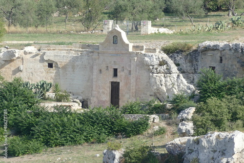 Madonna delle Vergini rupestrian church in Murgia Materana Park with an arched entrance carved into the rock introducing in the cave