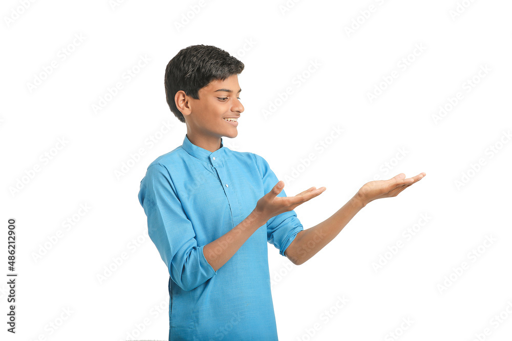 Indian boy in traditional wear and giving hand expression on white background. Indian boy in traditional wear and giving hand expression on white background.