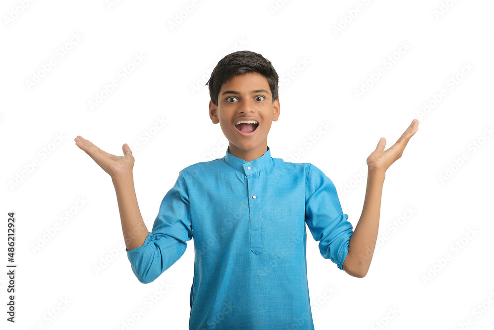 Indian boy in traditional wear and giving hand expression on white background. Indian boy in traditional wear and giving hand expression on white background.