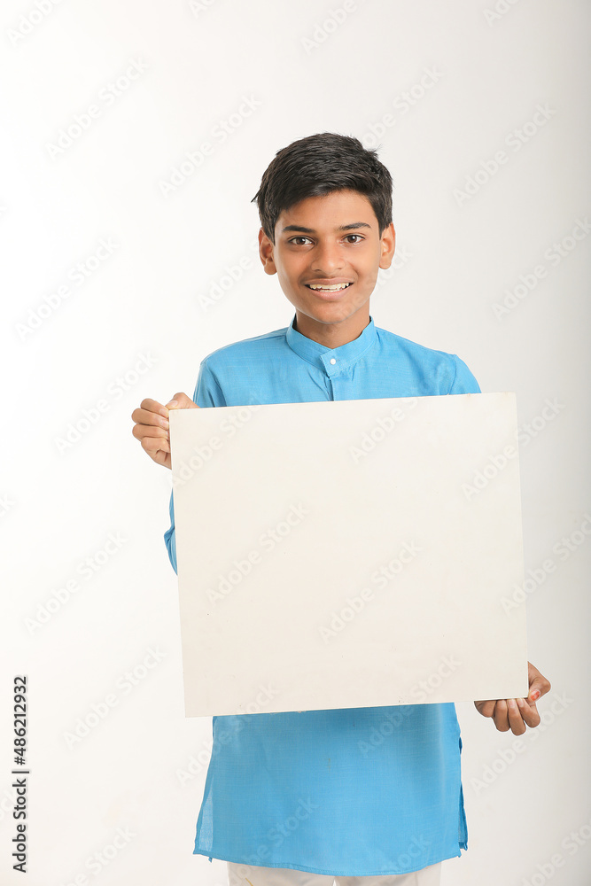 Indian little child in traditional wear and showing white board. Indian little child in traditional wear and showing white board.