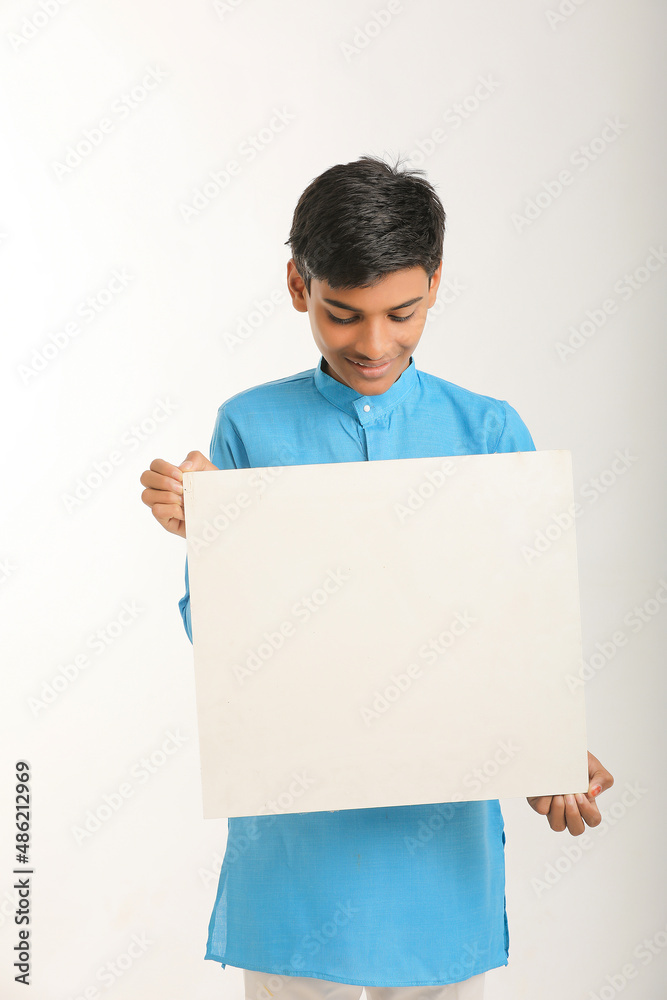 Indian little child in traditional wear and showing white board. Indian little child in traditional wear and showing white board.