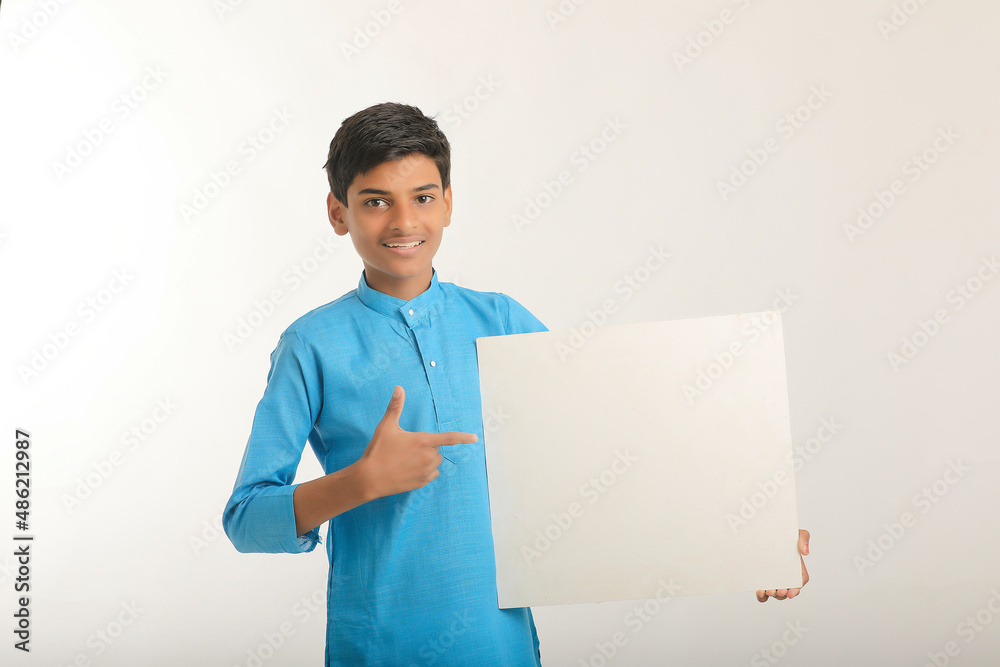 Indian little child in traditional wear and showing white board. Indian little child in traditional wear and showing white board.