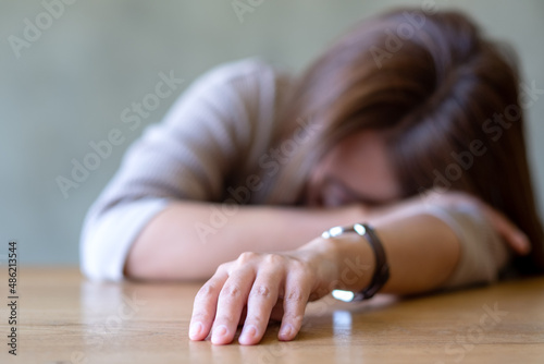 A young woman get tired and asleep on the table