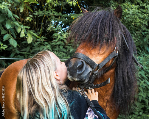 little caucasian white girl with her pony horse