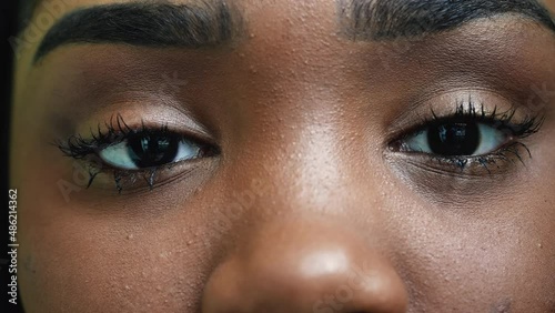 An African young woman macro eyes close-up looking at camera photo
