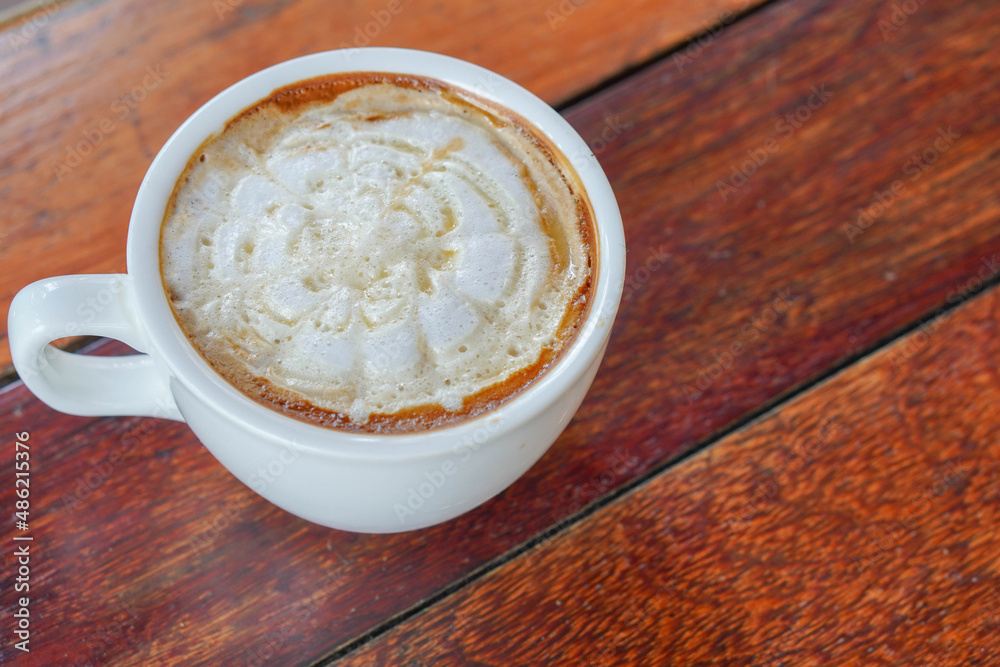 closeup hot coffee in white ceramic cup on a wooden floor background, food, drink, copy space closeup hot coffee in white ceramic cup on a wooden floor background, food, drink, copy space