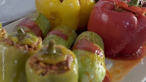 Stuffed meal at a table served by the chef.Mixed Dolma dishes of Middle Eastern pepper and zucchini stuffed with rice herb and spices.