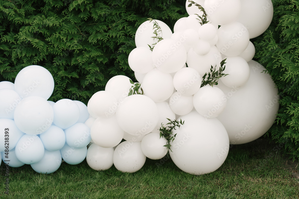 Decorations for holiday party. A lot of balloons blue and white colors. Round photo zone with balls