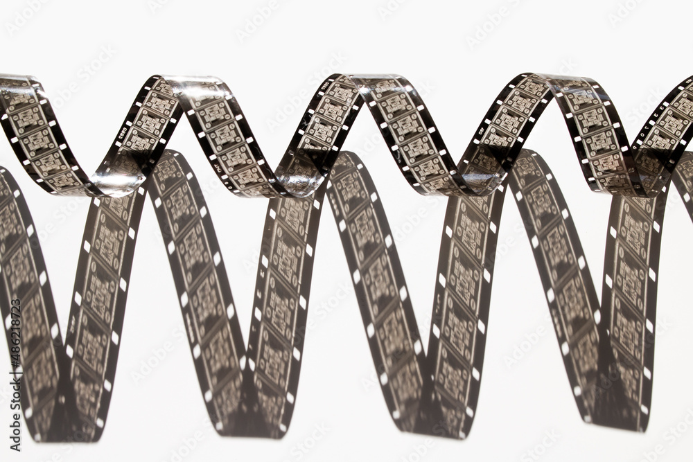 narrow, 16mm film on white background narrow, 16mm film on white background