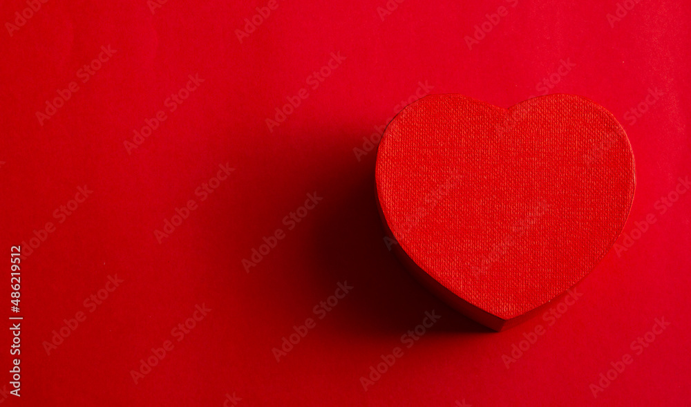 Red heart on red background with space for text. Flat lay, top view Red heart on red background with space for text. Flat lay, top view